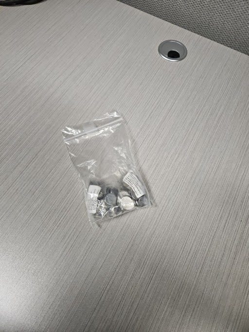 A sealed bag of finished pouch cells on a desk